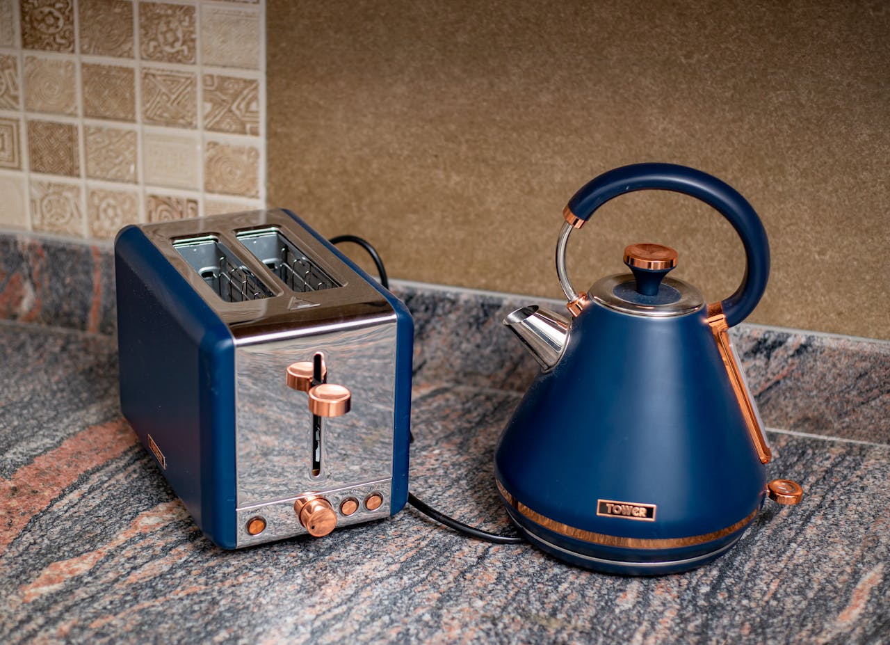 service-03 Stylish blue kettle and toaster set on a granite kitchen counter, adding a modern touch.